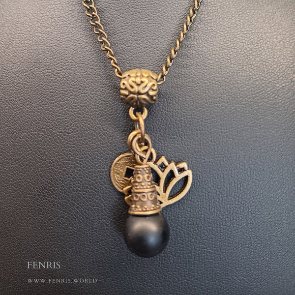bronze lotus and coin charm necklace with black obsidian